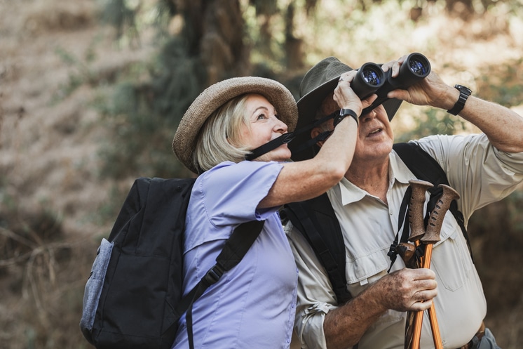 Happy retired couple enjoying nature in the Californian forest